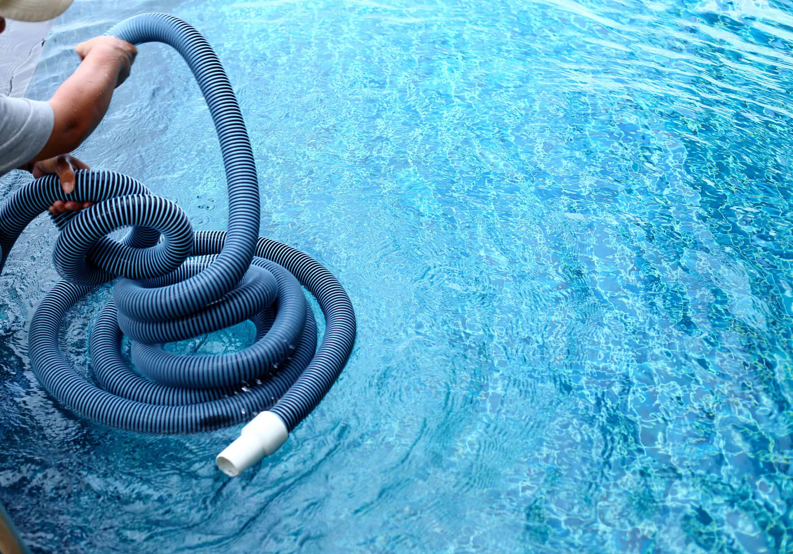 Pool service technician prepares to service a pool.