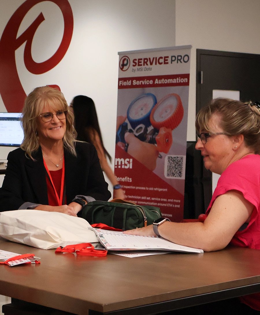 MSI employee speaking with someone at a trade show.