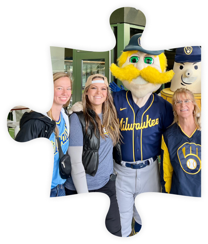 Puzzle piece with a photo of MSI Data employees at a Brewers game, posing with mascot.
