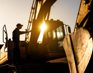 Field service worker operating a large piece of machinery.