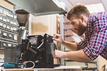 Service Pro for NetSuite - Technician Repairing Maintaining Coffee Machine