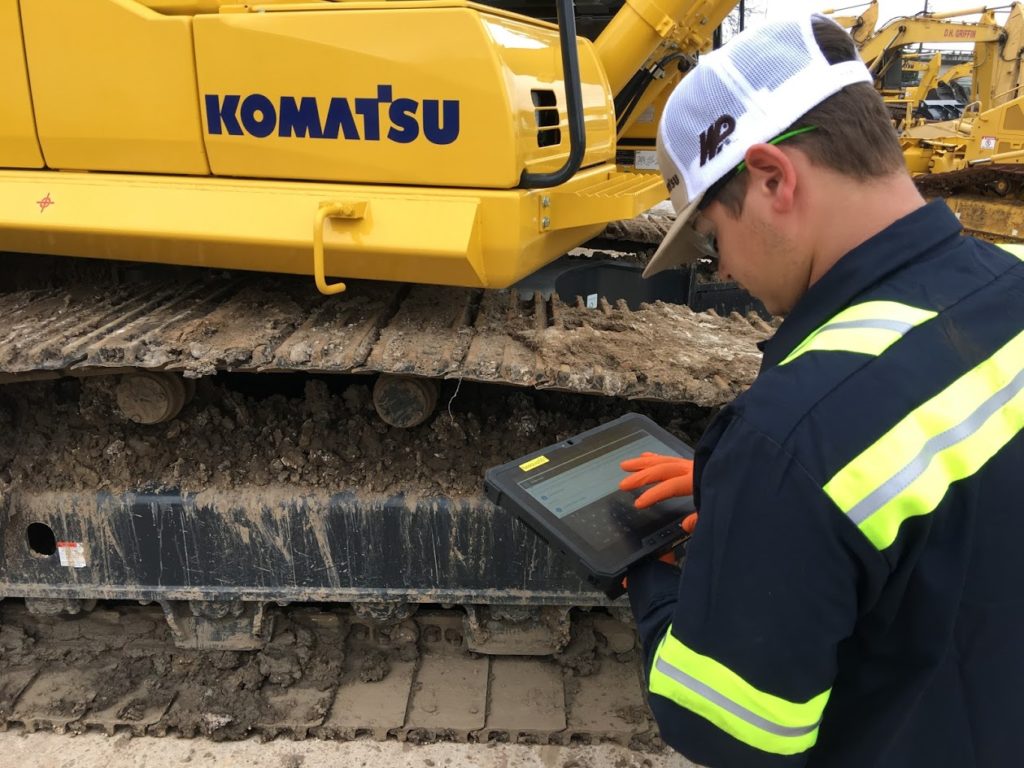 Construction equipment field technician uses Service Pro Mobile to complete equipment inspection