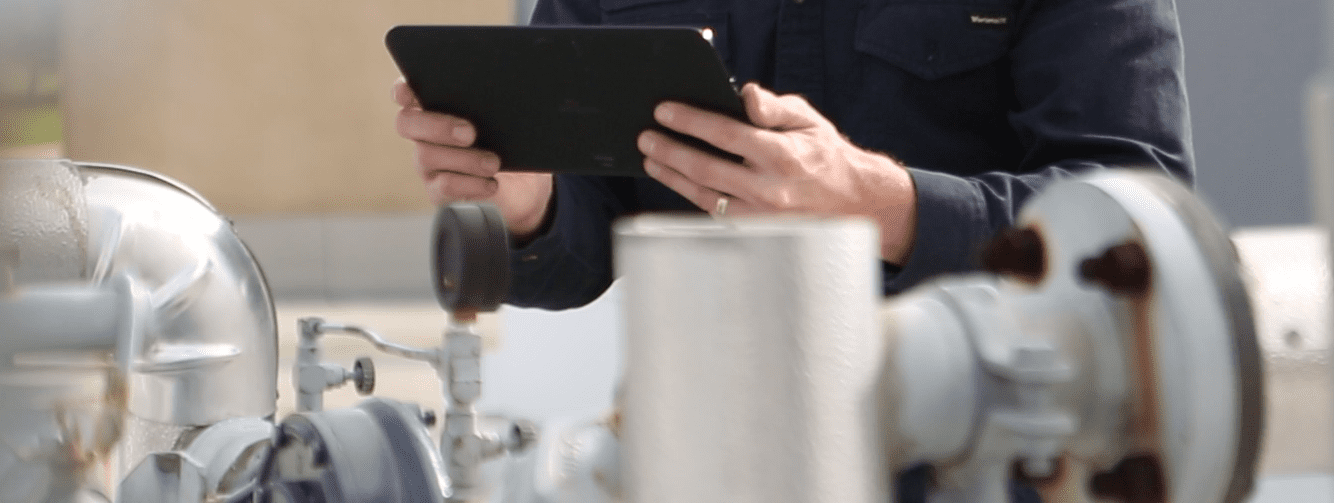 field service management - service pro software on ipad - technician on rooftop